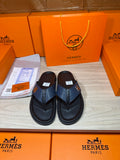 Luxury leather sandals in dark navy with wide toe straps and contoured black soles