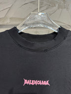 Black crewneck T-shirt with small pink Balenciaga logo