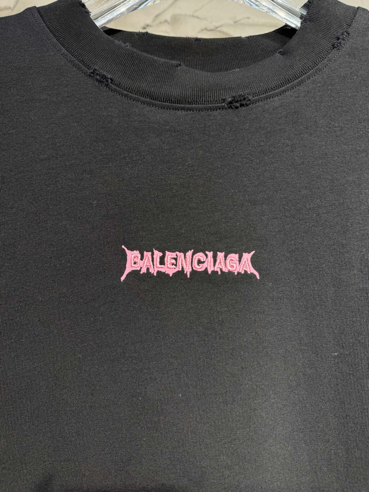 Black crewneck T-shirt chest detail with pink Balenciaga logo