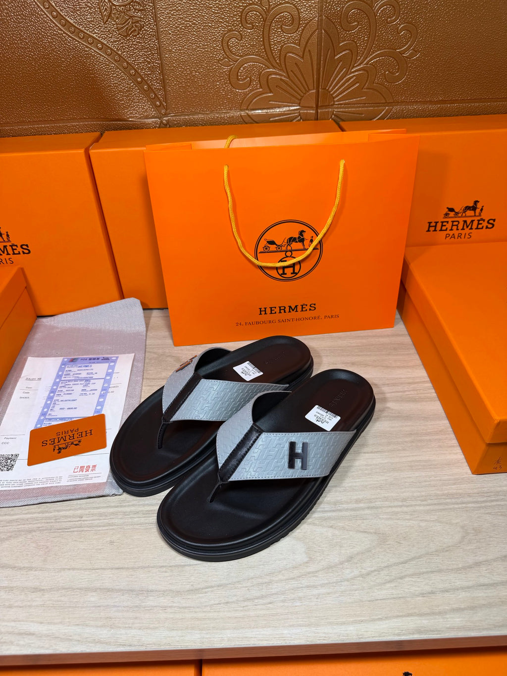 Pair of black thong sandals with gray H-strap and padded footbeds