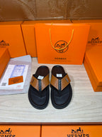 Hermes black leather thong sandals with tan strap and H logo buckle