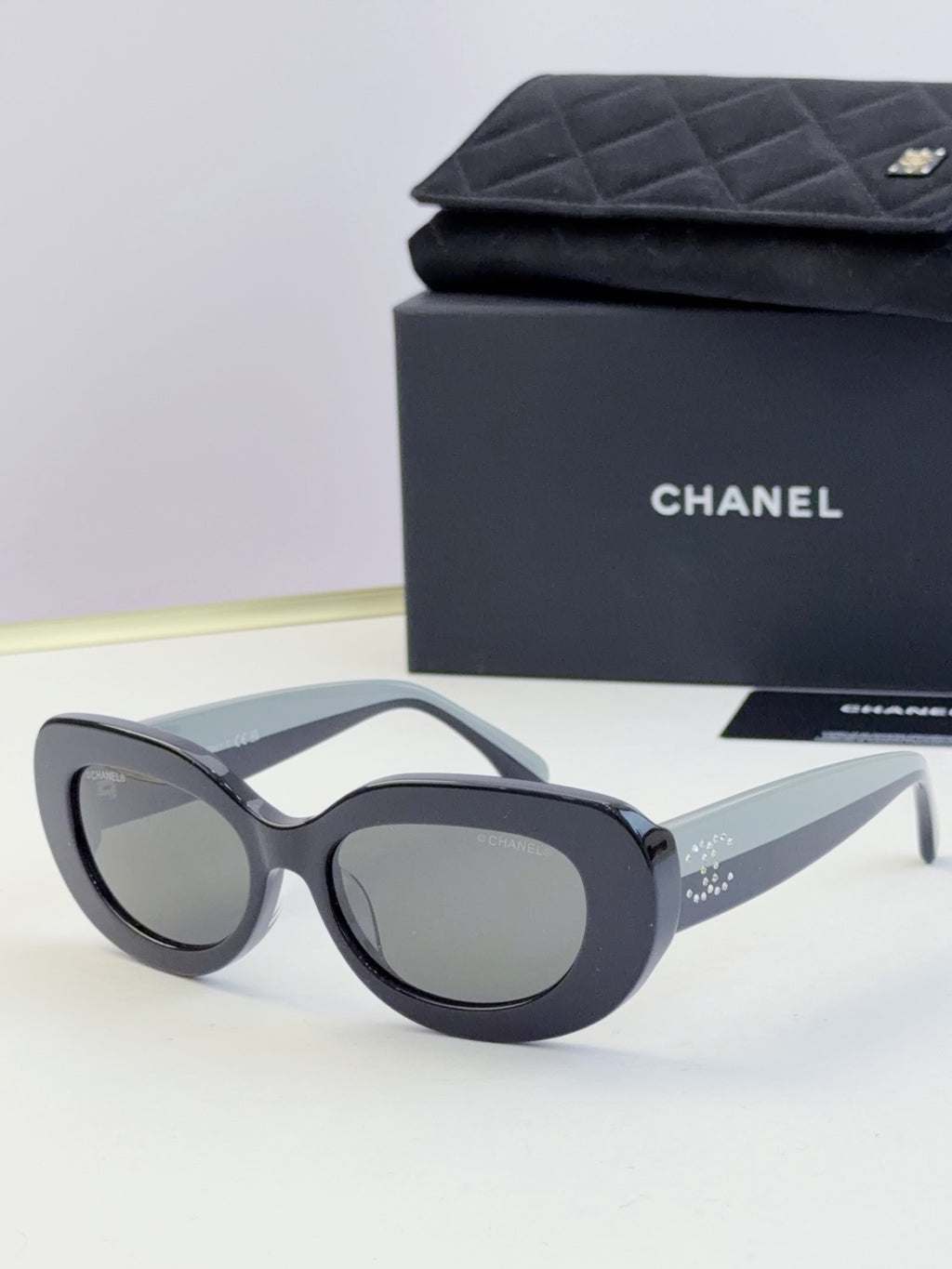 Chanel cat-eye sunglasses with gray frames and dark tinted lenses