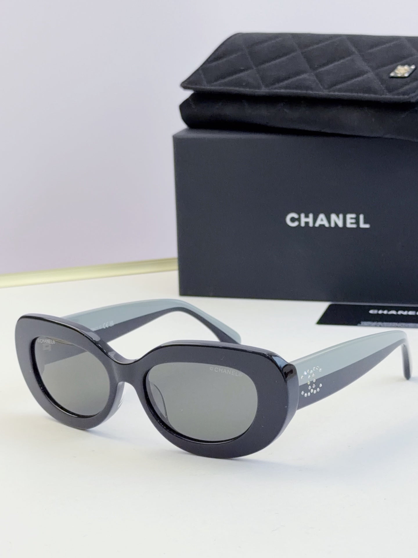 Chanel cat-eye sunglasses with gray frames and dark tinted lenses
