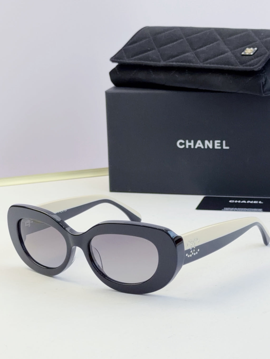 Chanel cat-eye sunglasses with dark frames and gray lenses