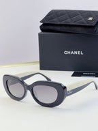 Chanel cat-eye sunglasses with dark frames and gray lenses