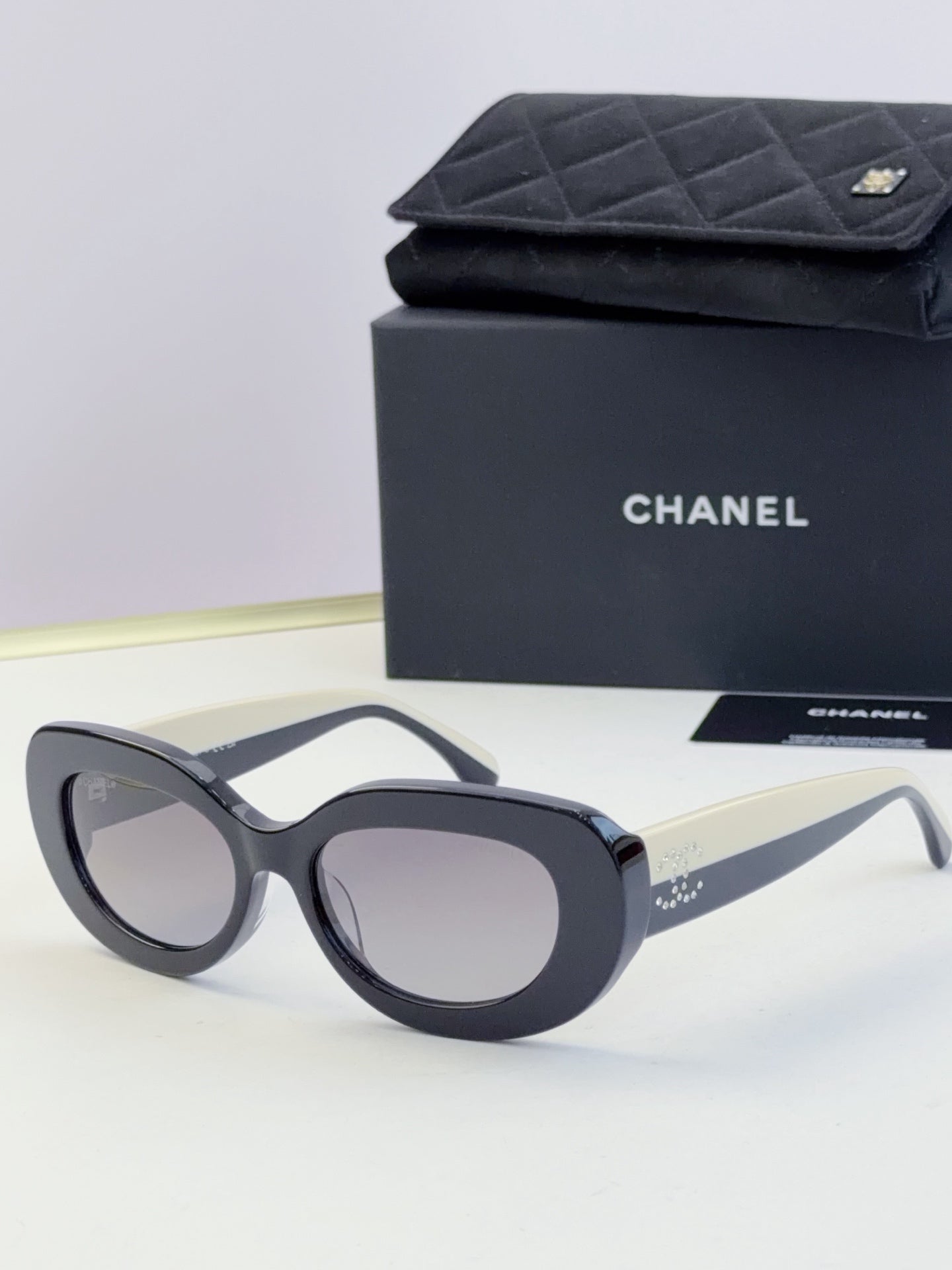 Chanel cat-eye sunglasses with dark frames and gray lenses