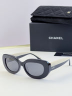 Chanel cat-eye sunglasses, dark navy frames with tinted gray lenses