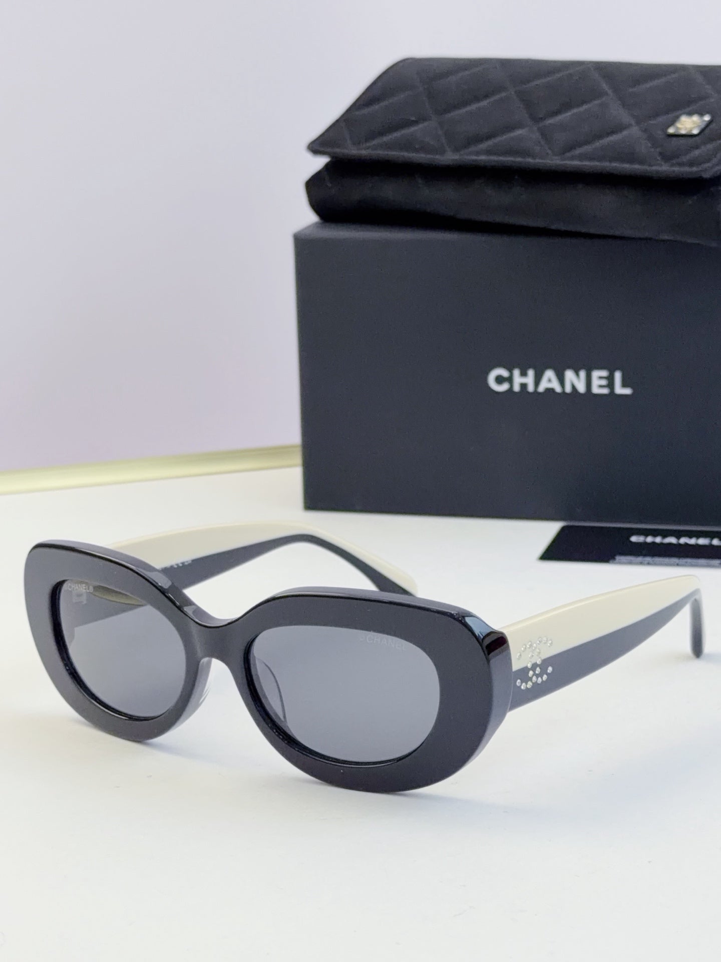 Chanel cat-eye sunglasses, dark navy frames with tinted gray lenses