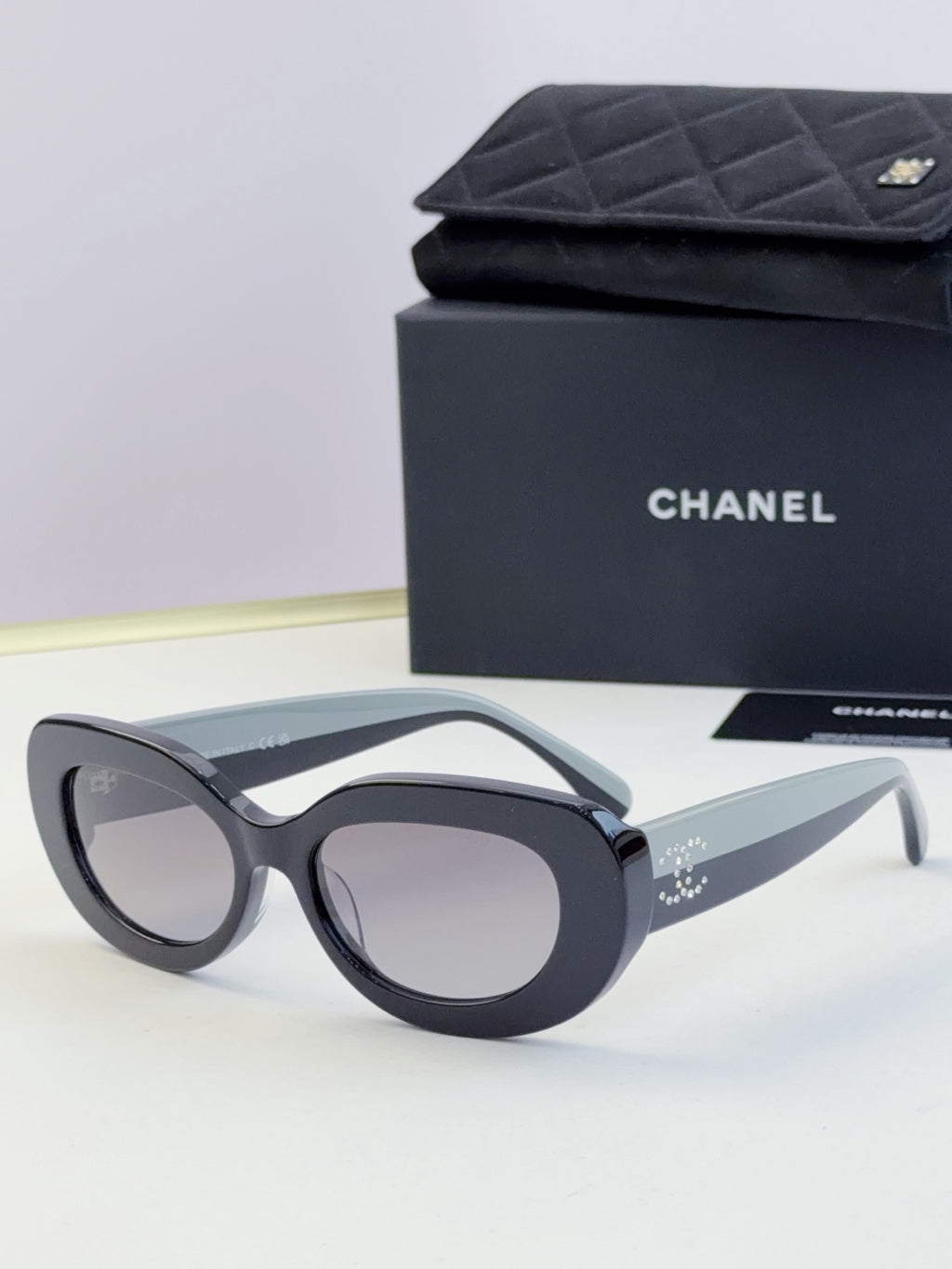 Chanel cat-eye sunglasses with dark frames and tinted gray lenses