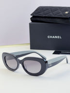 Chanel cat-eye sunglasses with dark frames and tinted gray lenses