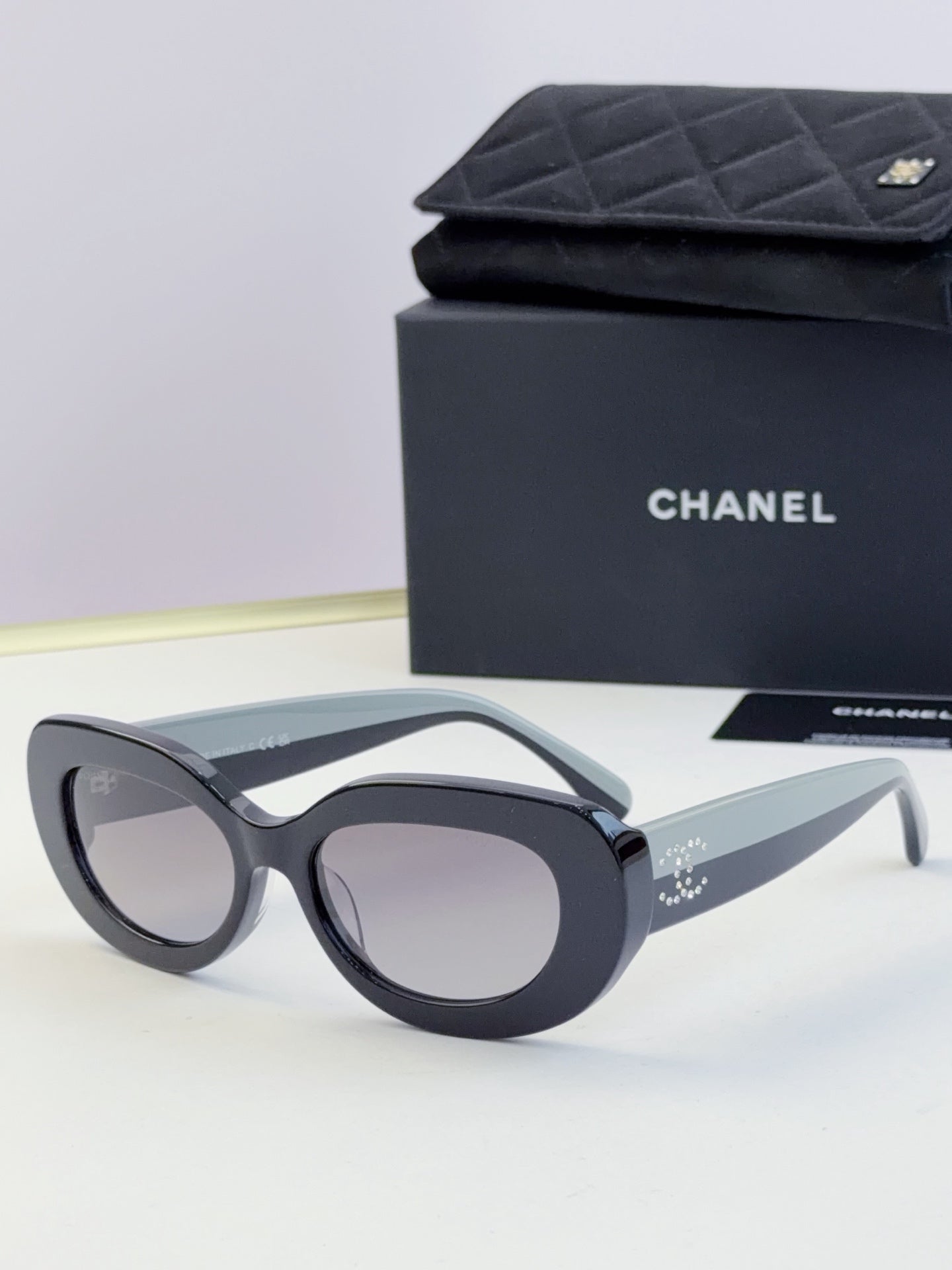 Chanel cat-eye sunglasses with dark frames and tinted gray lenses