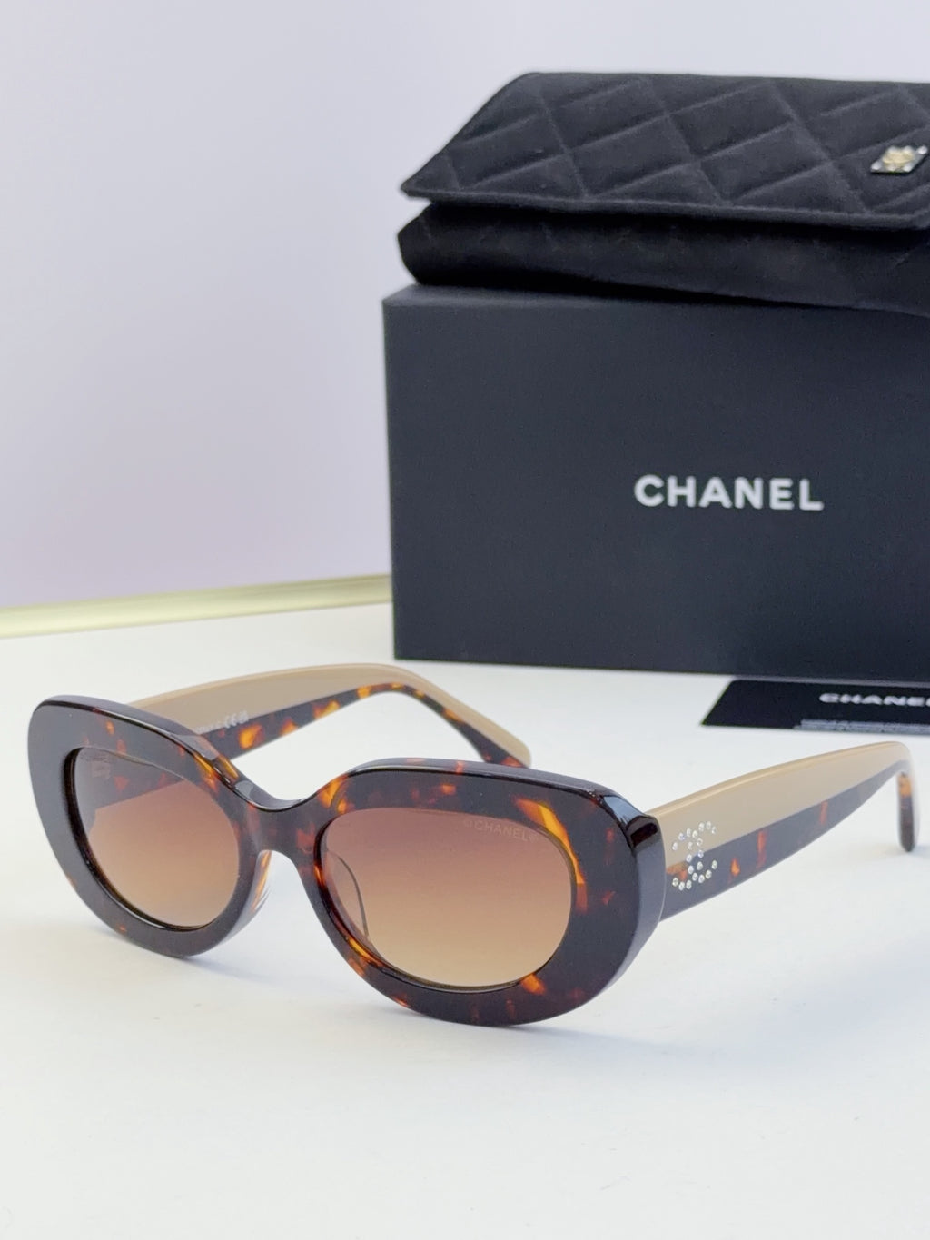 Chanel cat-eye sunglasses with tortoiseshell frames and brown tinted lenses