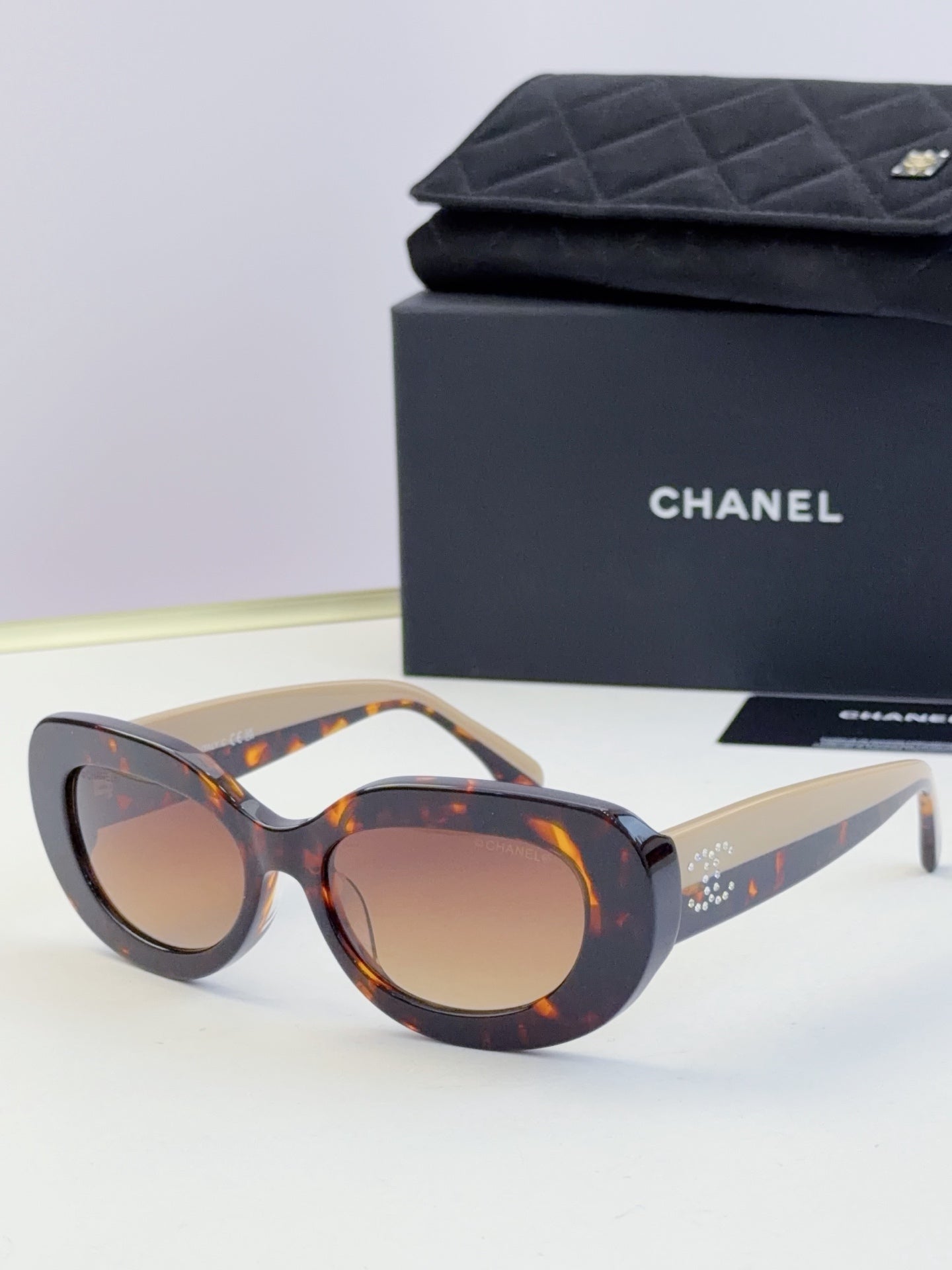 Chanel cat-eye sunglasses with tortoiseshell frames and brown tinted lenses