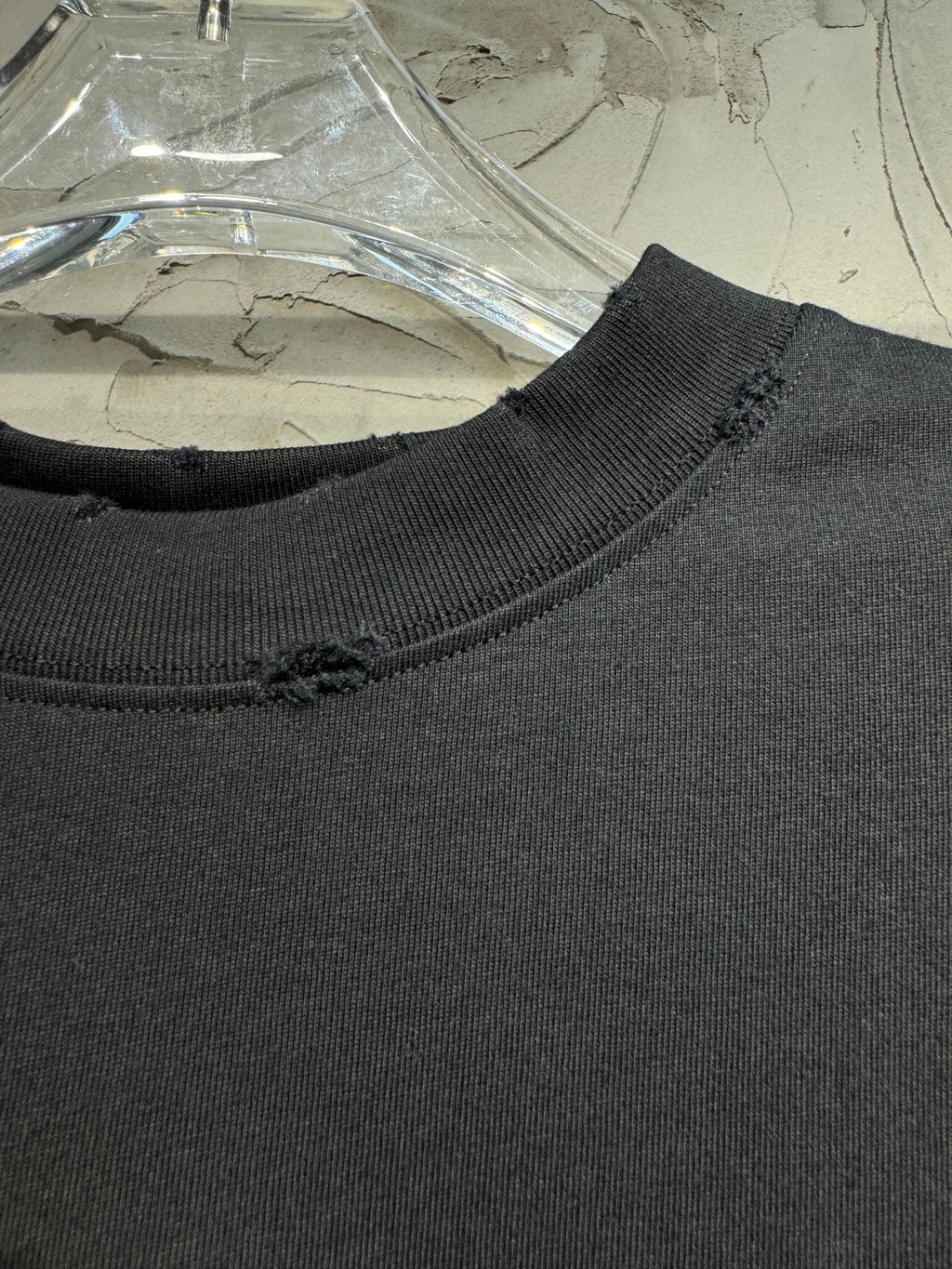 Dark ribbed neckline of a short-sleeve top