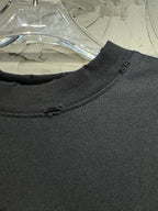 Dark ribbed neckline of a short-sleeve top