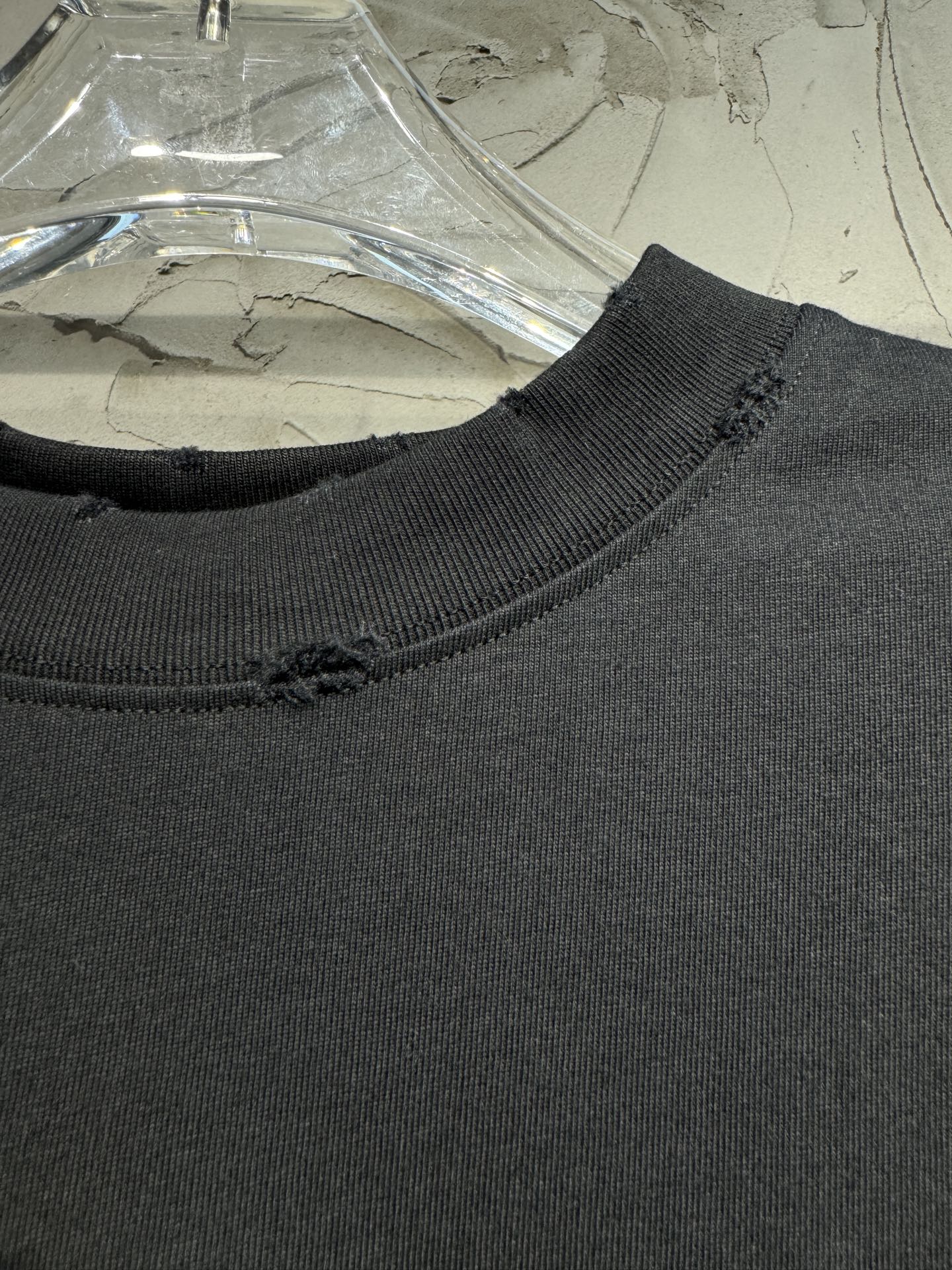 Dark ribbed neckline of a short-sleeve top