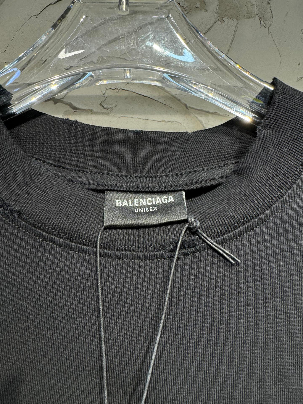 Black crewneck T-shirt collar label: Balenciaga Unisex on tag