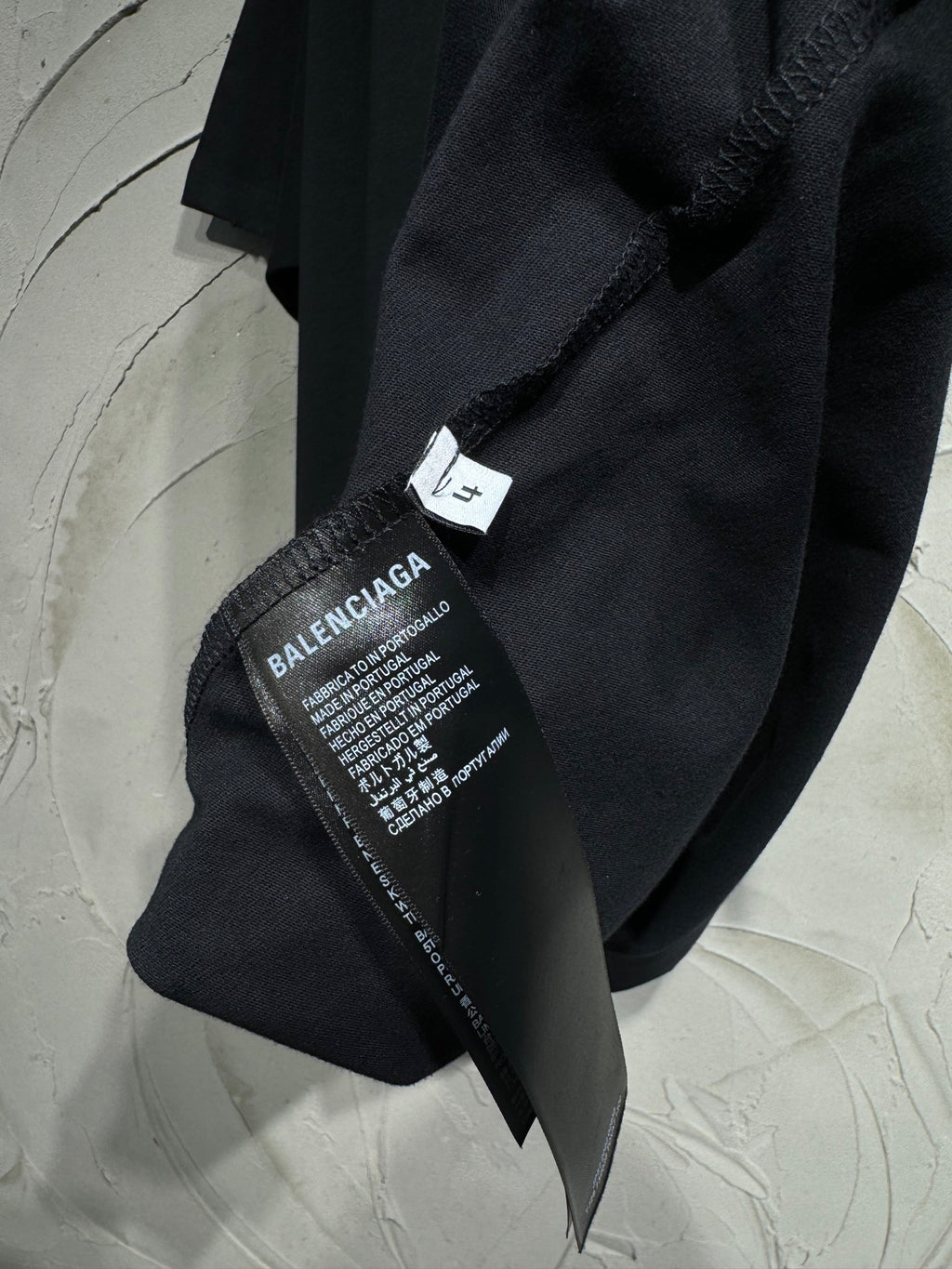 Black T-shirt with Balenciaga size and care label at side seam