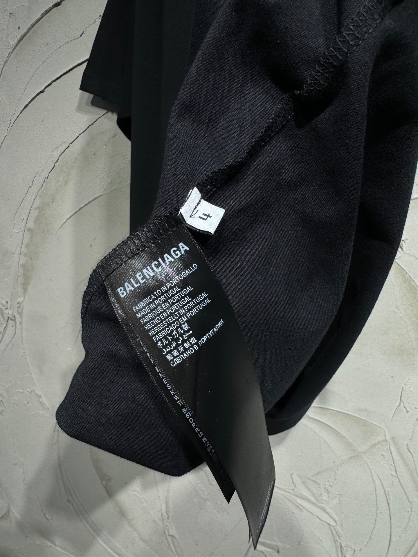 Black T-shirt with Balenciaga size and care label at side seam