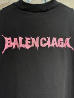 Black T-shirt detail: pink Balenciaga lettering graphic