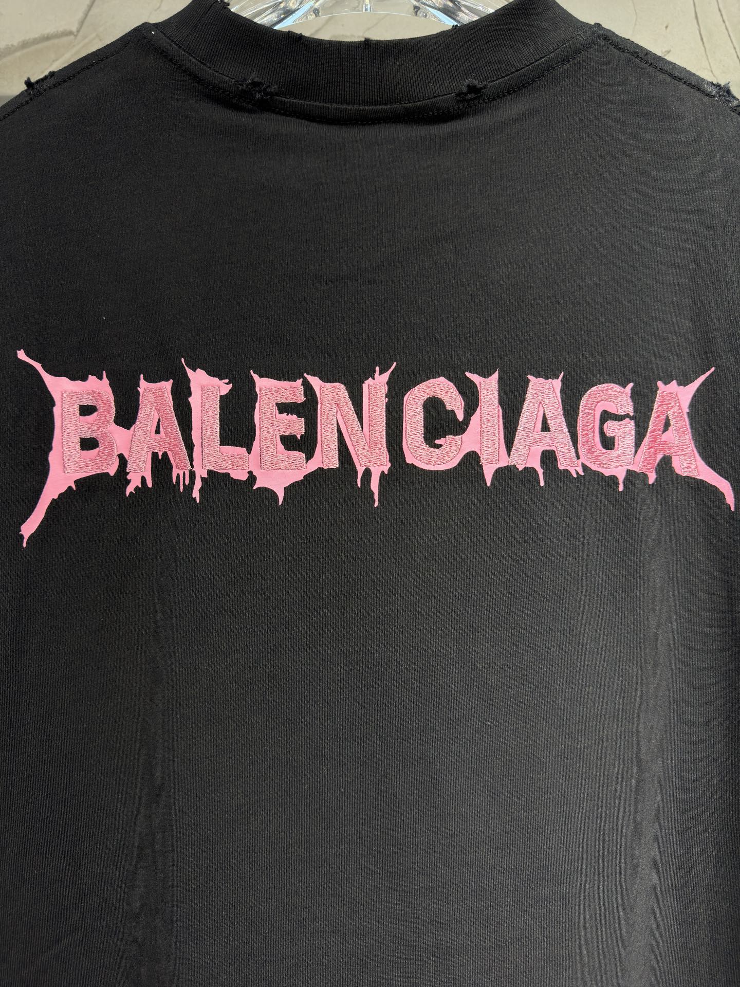 Black T-shirt detail: pink Balenciaga lettering graphic