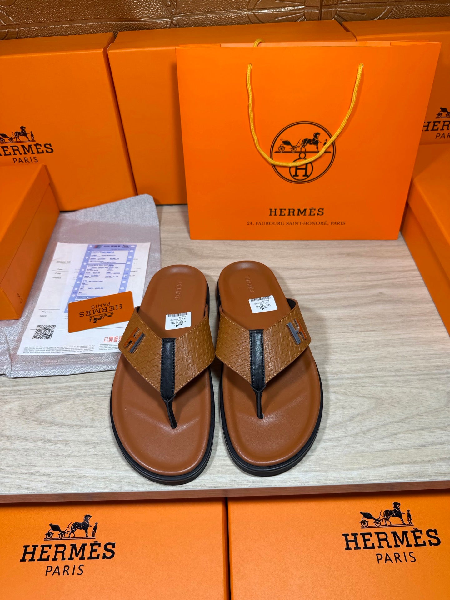 Hermes thong sandals with brown footbed, blue straps, H logo; boxed pair