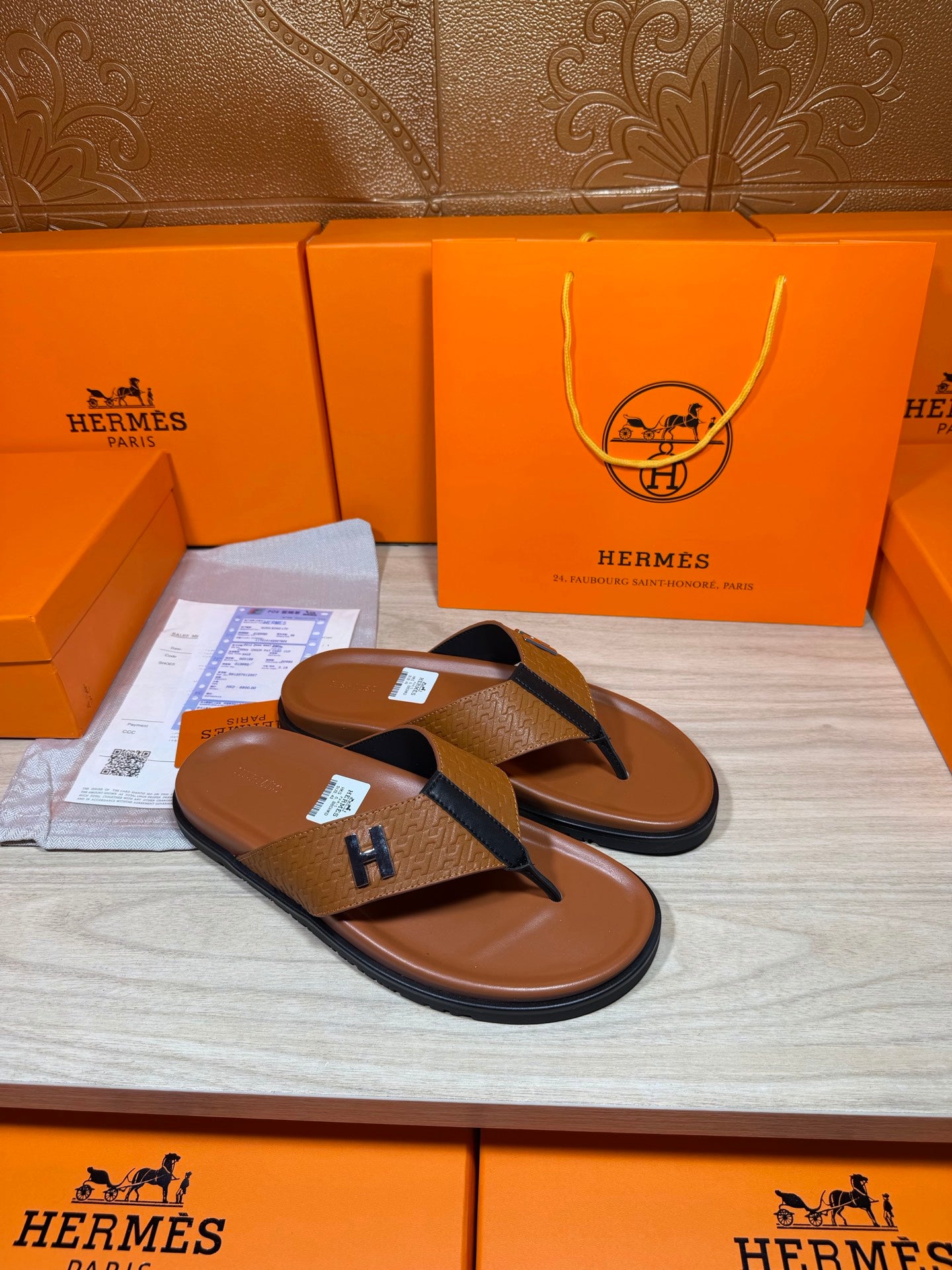 Hermes thong sandals with brown footbed and blue strap, H logo; angled pair