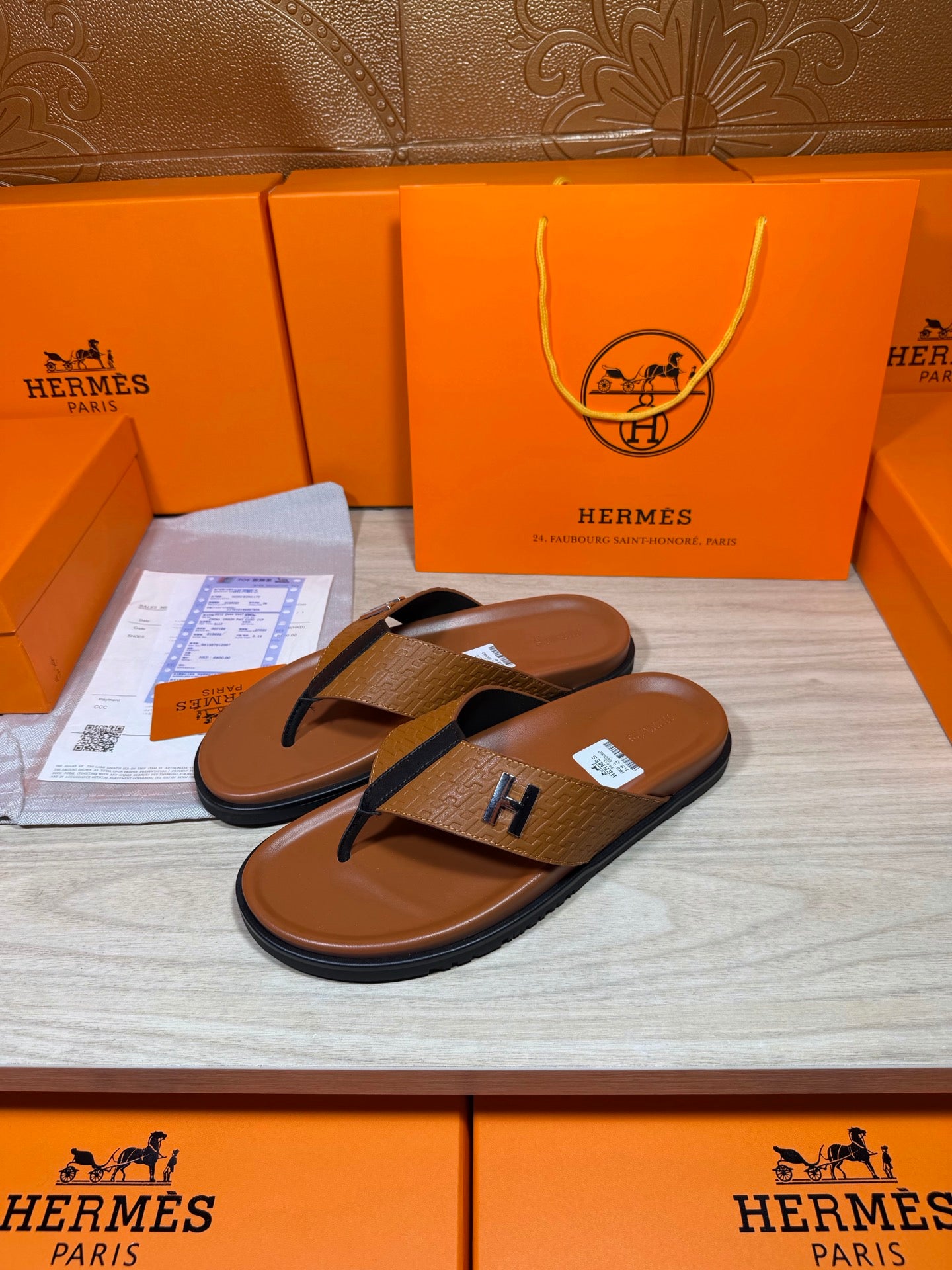Hermes thong sandals with brown footbed, blue straps, H logo; side view