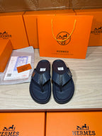 Hermes leather sandals in dark blue, two straps and logo H hardware, pair front view