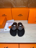 Brown and black H-logo thong sandals with textured strap and black footbed