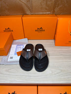Brown and black H-logo thong sandals with textured strap and black footbed