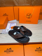Brown and black H-logo thong sandals with slim black sole and dark footbed
