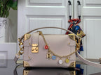 Louis Vuitton handbag in light pink leather with gold hardware and chain shoulder strap