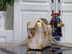 Louis Vuitton handbag in light pink leather with gold clasp and crossbody strap