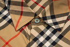 Plaid long-sleeve shirt detail: round buttons and stitched pocket area