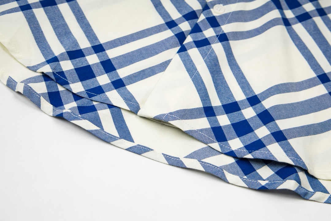 Burberry plaid shirt sleeve and side hem detail, blue-and-cream stripes and checks