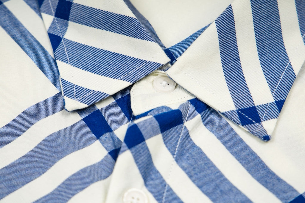 Burberry plaid shirt chest close-up with button placket and textured fabric, blue-and-cream