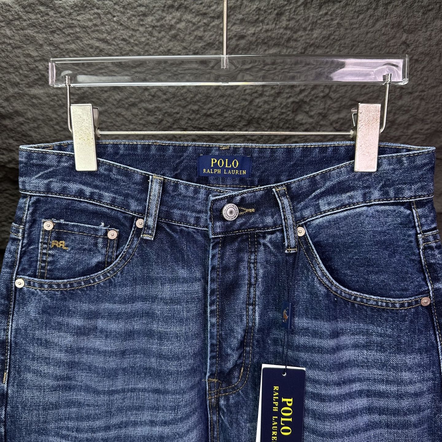 Blue denim jeans waistband with POLO Ralph Lauren logo and front pockets.