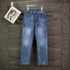 Blue denim jeans with straight leg, button-fly, and belt loops.
