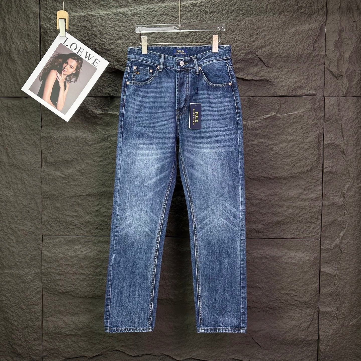 Blue denim jeans with straight leg, button-fly, and belt loops.