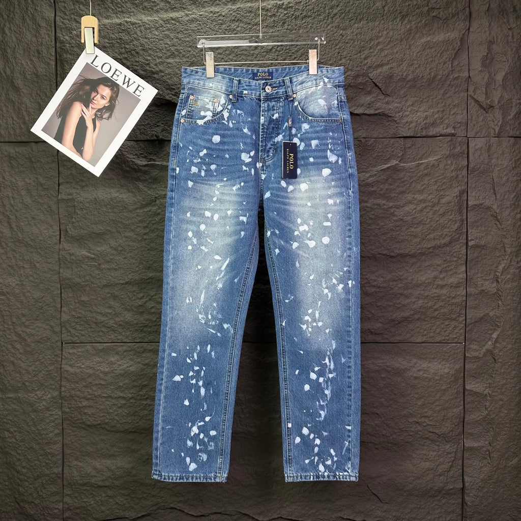 Blue denim jeans with white speckle print, button fly, straight legs.