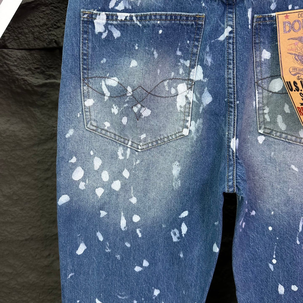 Ralph Lauren denim jeans with splatter-style white print, buttoned pocket detail
