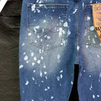 Ralph Lauren denim jeans with splatter-style white print, buttoned pocket detail