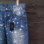 Blue denim jeans with white speckle print, front yoke details, hanging POLO tag.