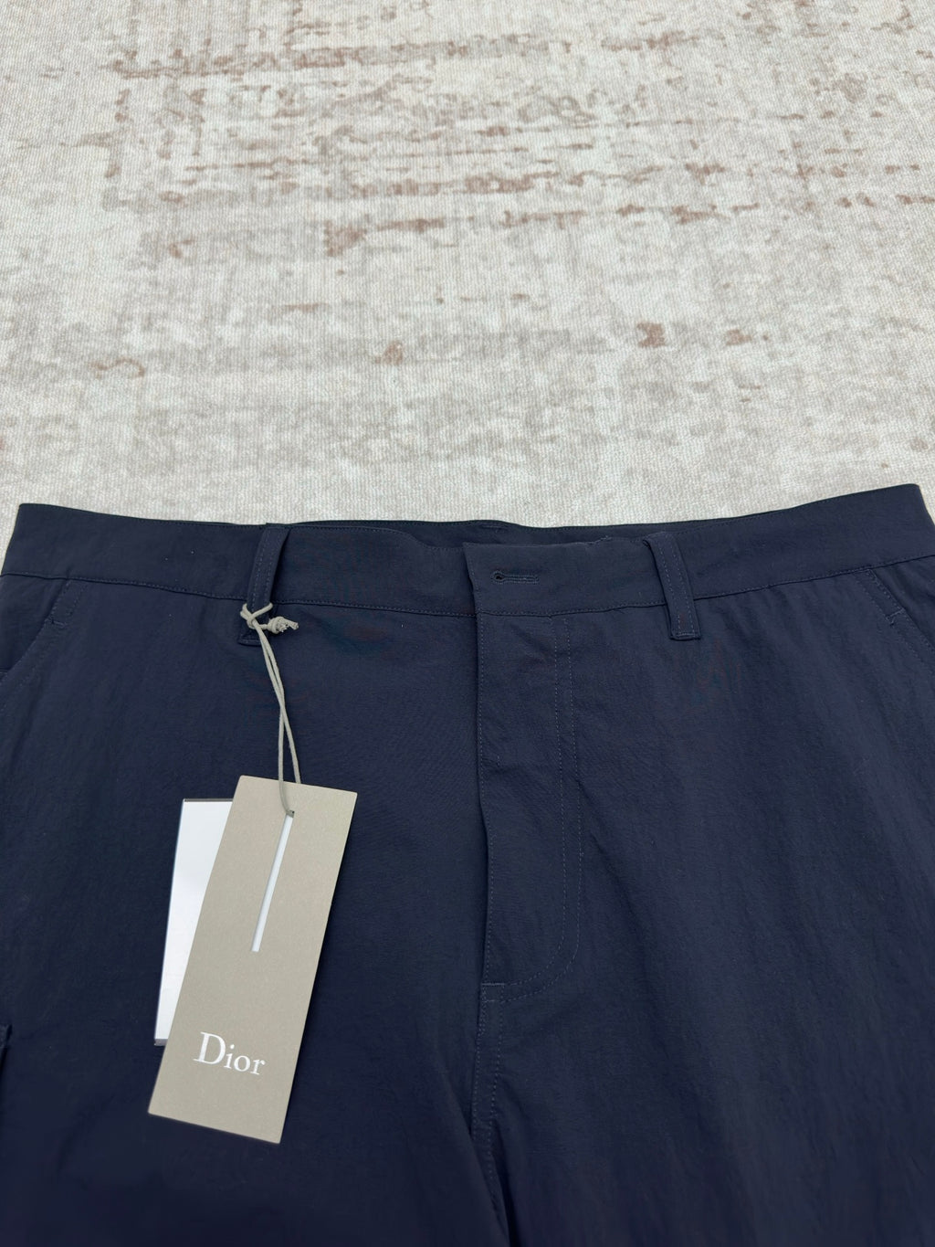 Dior navy pants with drawstring waist and hanging brand tag