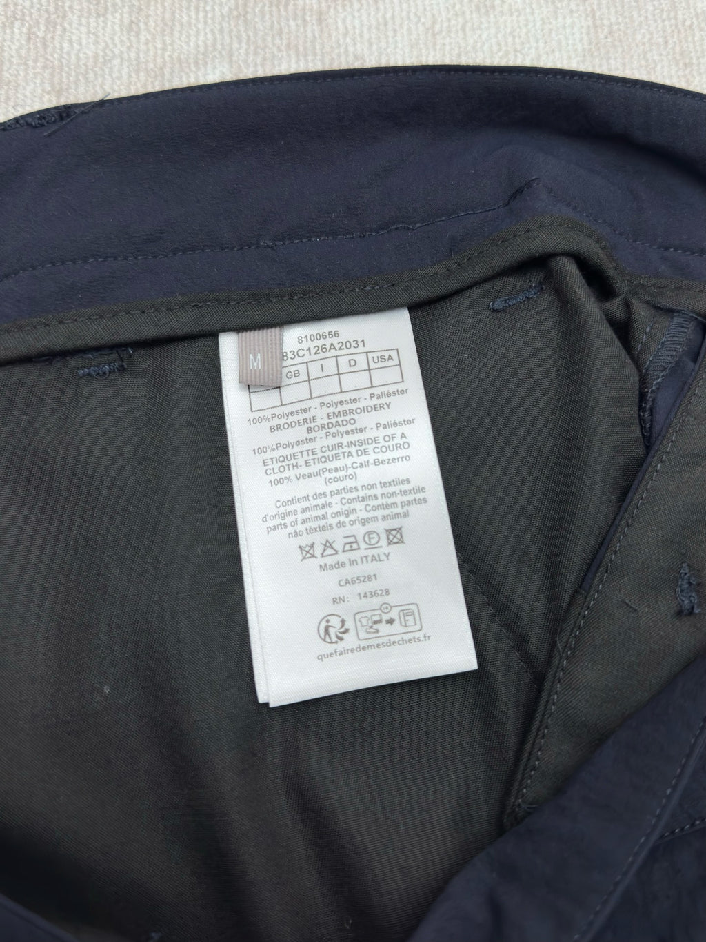 Dior navy pants with care label inside near the waistband
