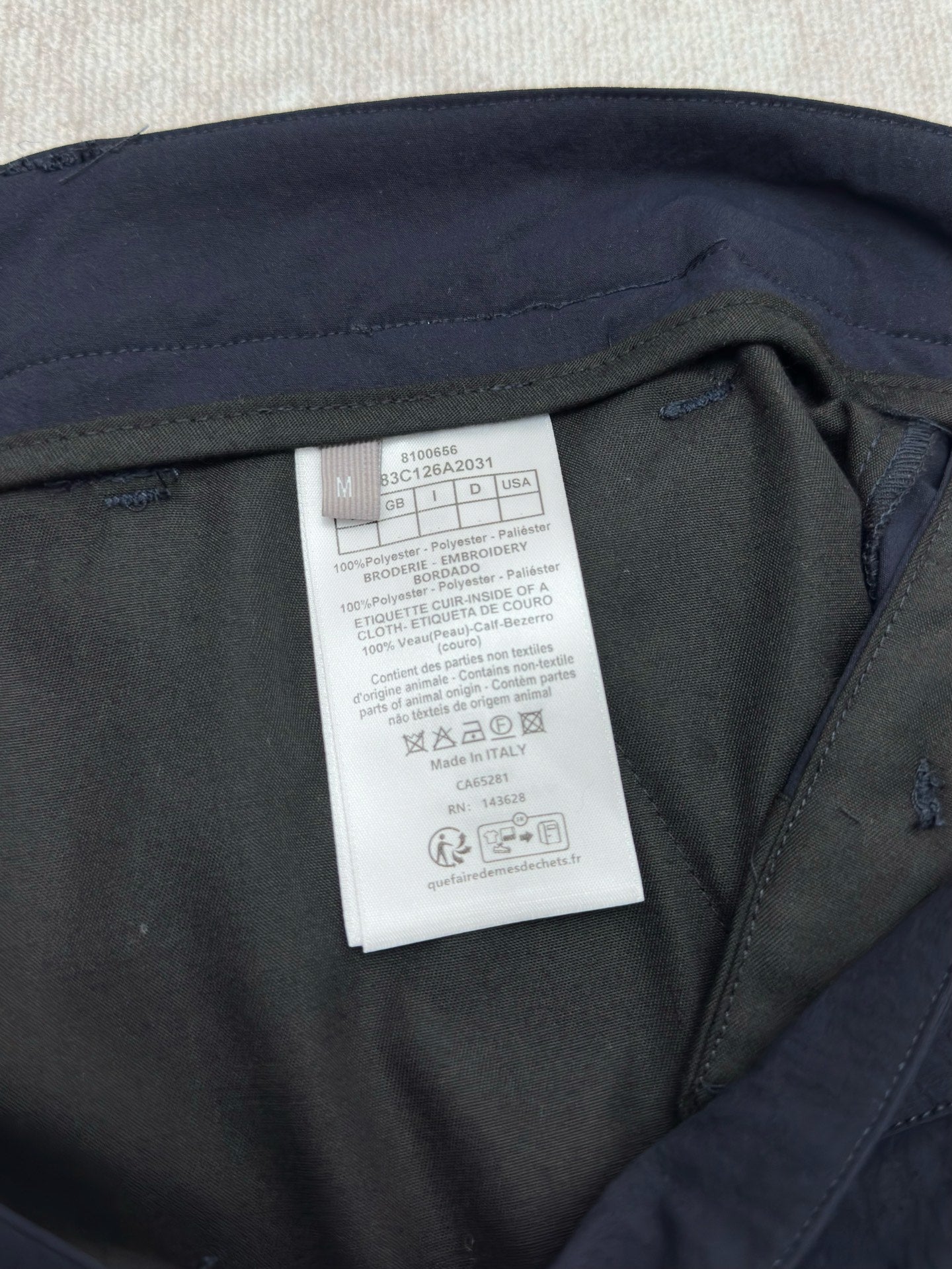 Dior navy pants with care label inside near the waistband