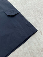 Dior navy cargo pant leg with stitched pocket and fold seam