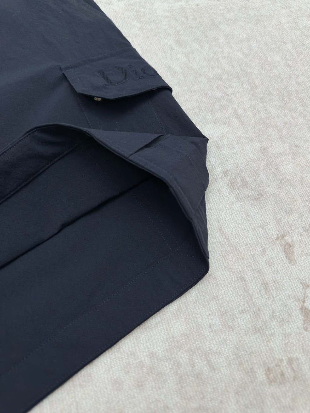 Dior navy cargo pant leg with flap pocket and side seam