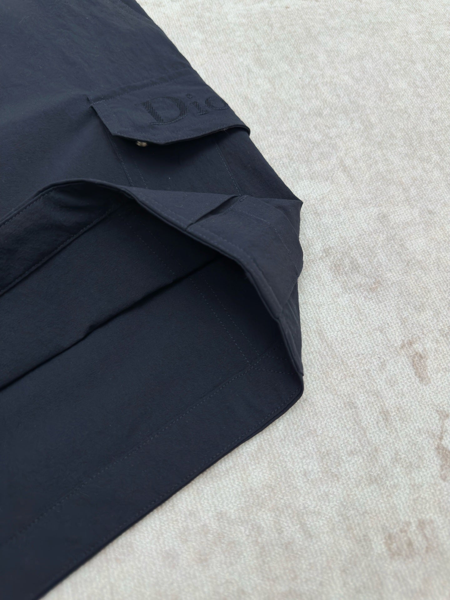 Dior navy cargo pant leg with flap pocket and side seam